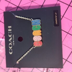 Coach Red and Orange Necklace with Vibrant Charm Design